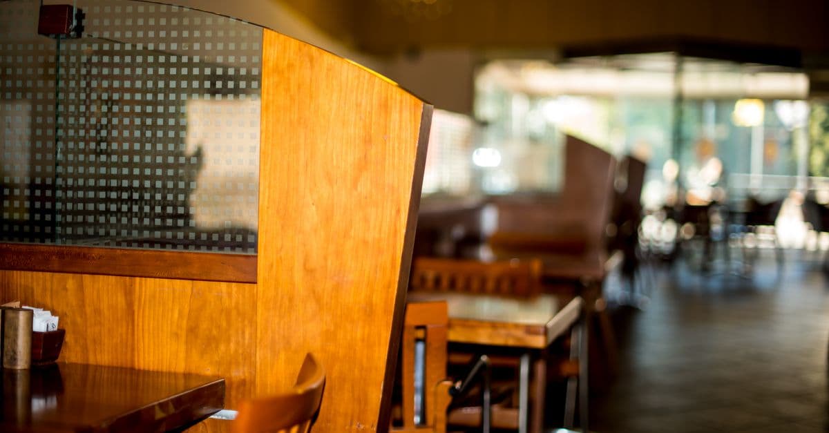 Warm, inviting restaurant interior featuring wooden tables and chairs. Perfect for dining settings.